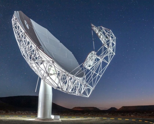 A close-up view of a single MeerKAT radio telescope dish in the Karoo, reflecting sunlight against a backdrop of rugged terrain, symbolizing cutting-edge astronomical research